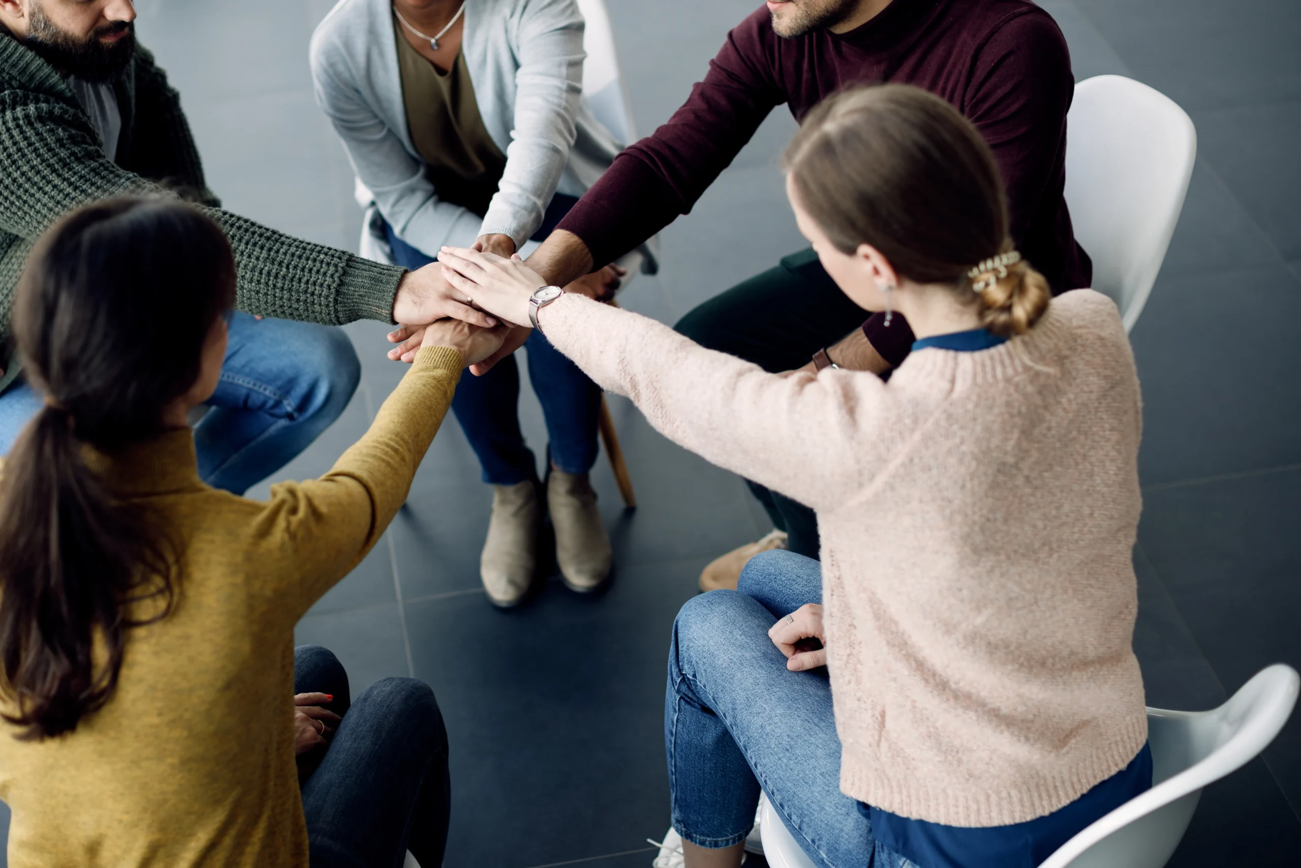 participants group therapy gathering hands unity session medical center